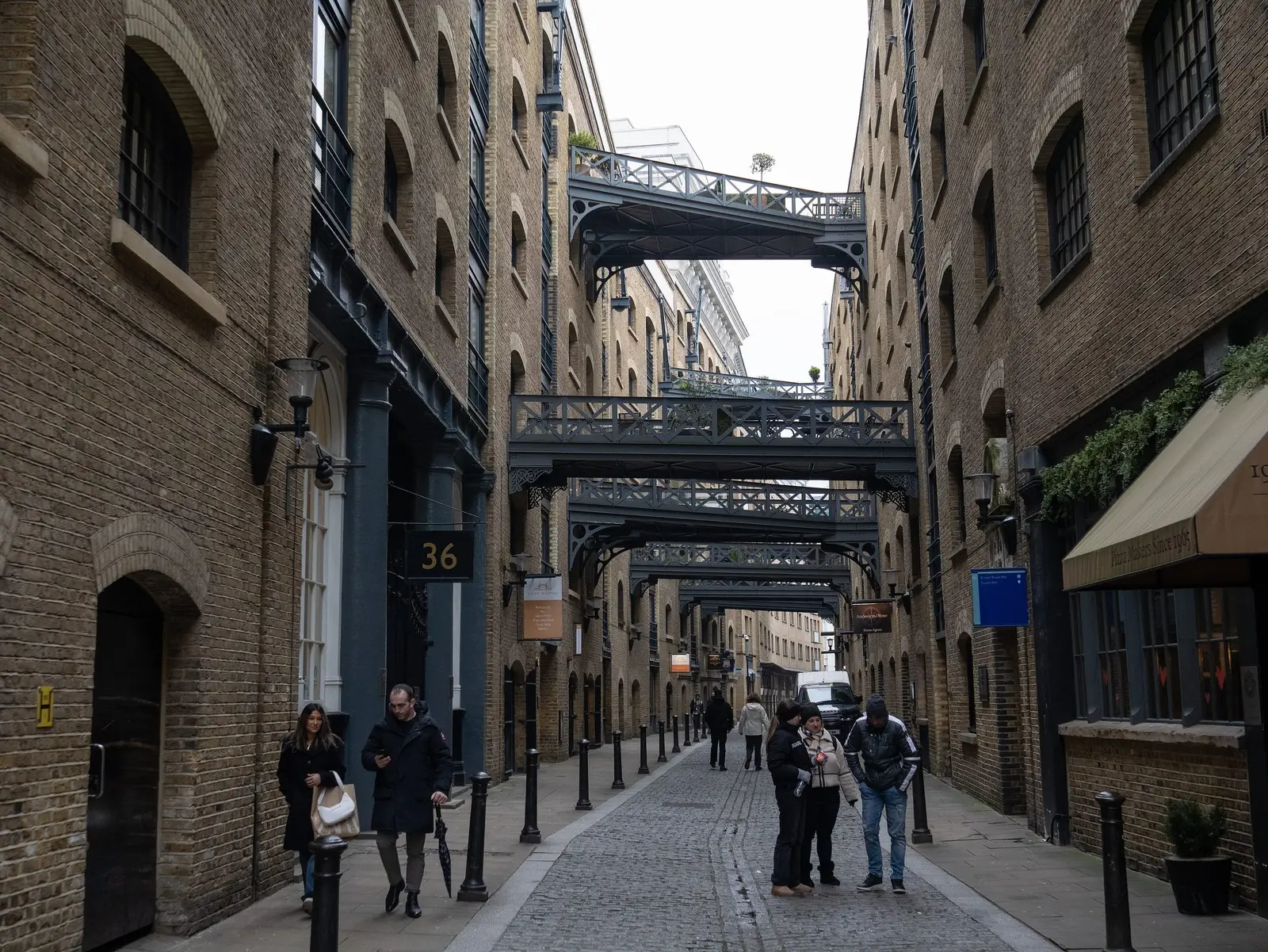 Shad Thames, a narrow street of old warehouses linked by iron walkways