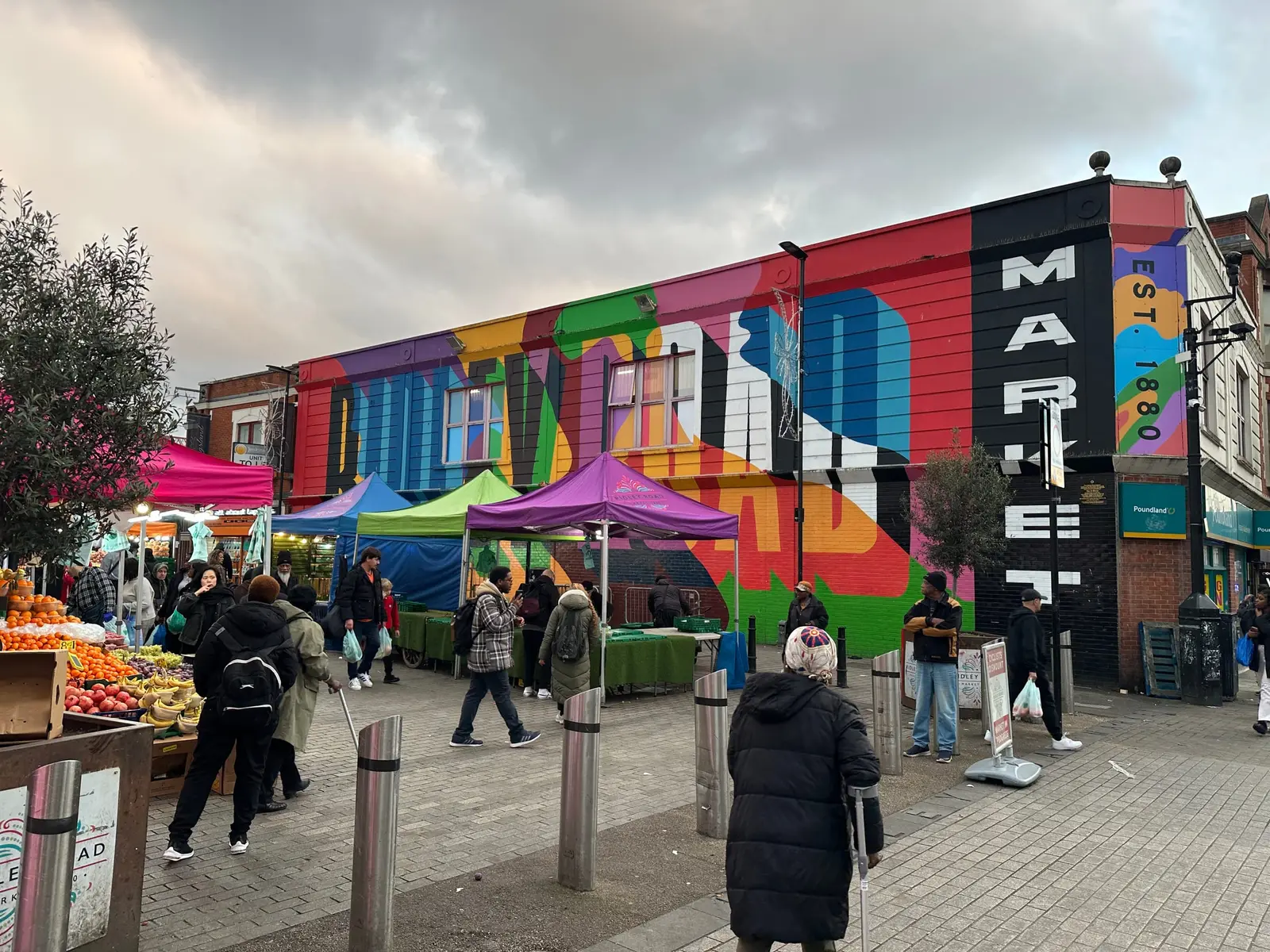 Ridley Road Market in Dalston with stalls in front of a colourful mural