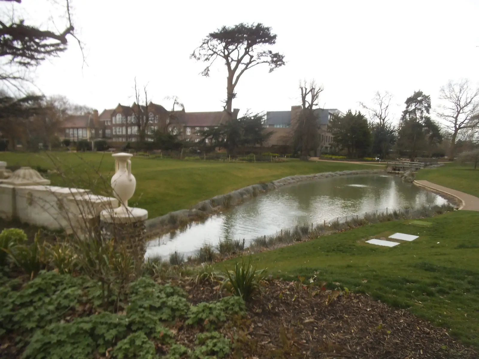 The pond in Walpole Park, Ealing, edged with trees and lawns