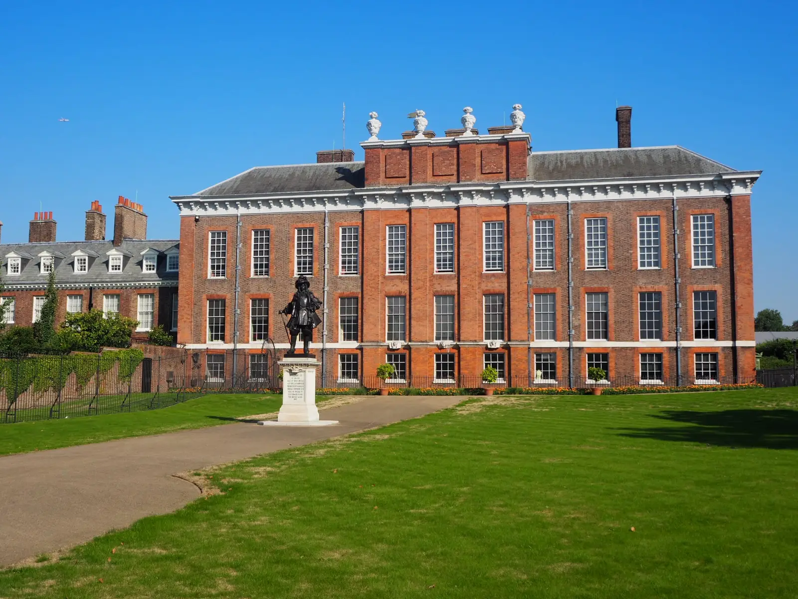 Kensington Palace’s red-brick front and statue across the lawn