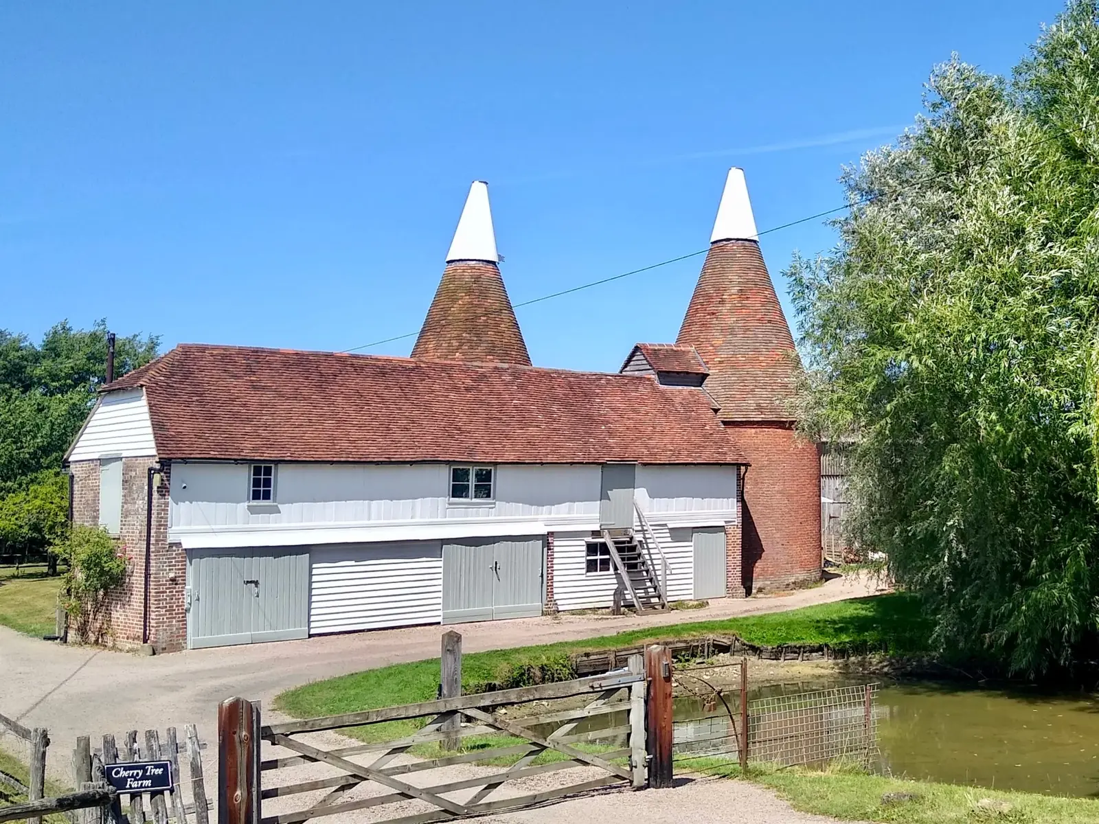 A white-cowled oast house on a farm in the Kent countryside