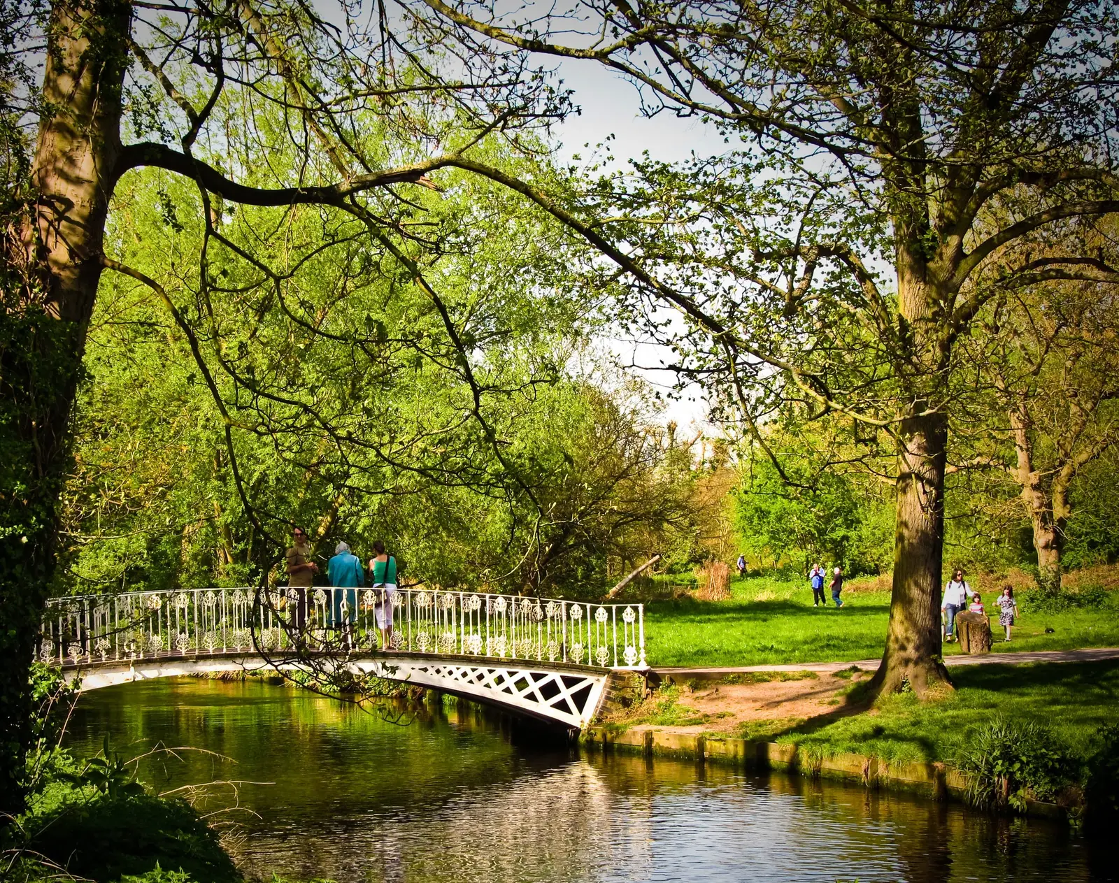 A white footbridge over the River Wandle in Morden Hall Park