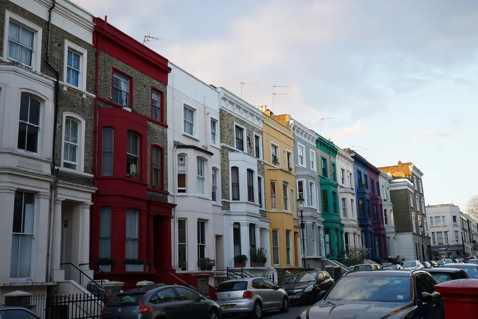 A row of pastel-painted terraced houses in Notting Hill